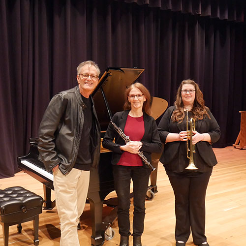 Mark Evans, Dr. Karen Hosmer holding an oboe, and Dr. Allyson Keyser holding her trumpet.