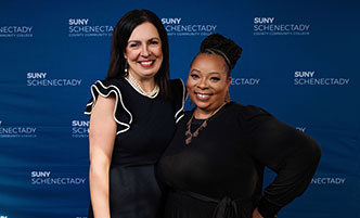 Two members of the President's Cabinet pose at a formal events. 