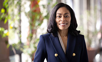 Dr. Reaves wearing a navy jacket with gold buttons. 