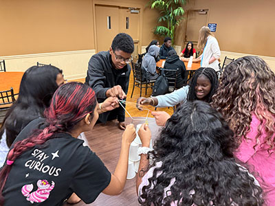 Early College High School students working together at table.
