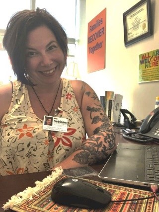 Martina Swiers sitting at her desk at work. 