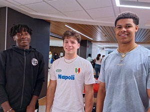 Four students standing together in the commons. 