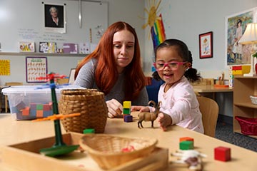 Early Childhood student working with a child in the Integrated Preschool Laboratory.