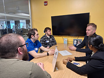 Chris Wessell '00, Managing Partner of PeopleWise, meets with business students during a Speed Networking event. 