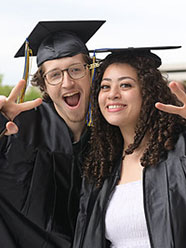 Two happy graduates posting for a photo.