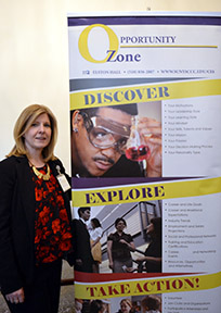 Dawn Jones, Assistant Director of Career Services, standing by a Career Services banner.