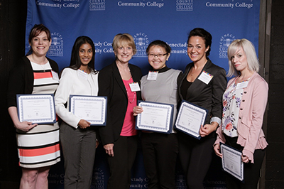 Five scholarship recipients standing with their scholarship donor.