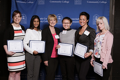 Five scholarship recipients standing with their scholarship donor.