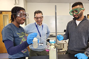 Dr. Luca Fontana with two students in the Chemistry Lab