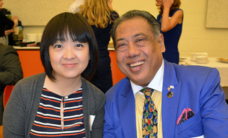 A female student sits with a scholarship donor at an event.