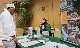 Student speaking with a recruiter at an employment fair.