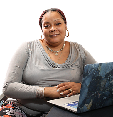 Female student in seated in front of a laptop.