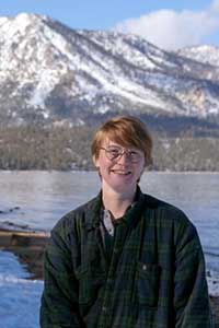 Headshot of Lawrence Lorraine Mullen in front of snow capped mountains. 