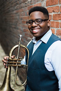Omar Williams holding a trumpet