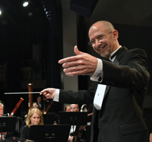 Brett Wery conducting with baton in hand