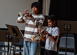 Two trumpet students playing togther on stage.