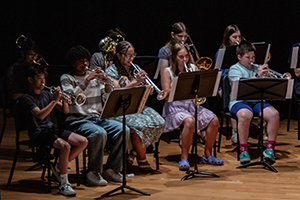 Trumpet camp students on stage with students from the Trombone Camp.