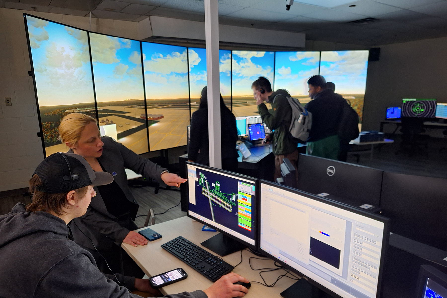 Instructor showing student how to use Air Traffic Control Simulator