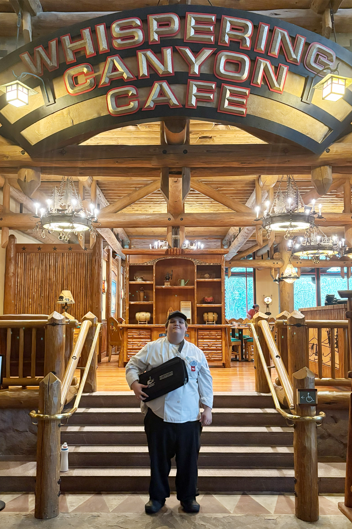 Adam Toucette in chef's uniform, standig in front of Whispering Canyon Café, Disney World