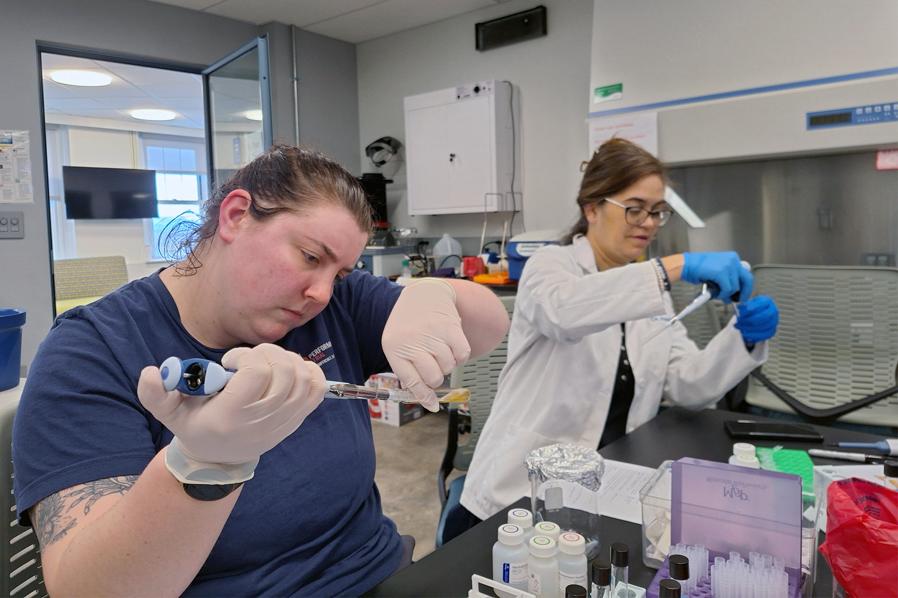 Student using pipette in Biotech Facility