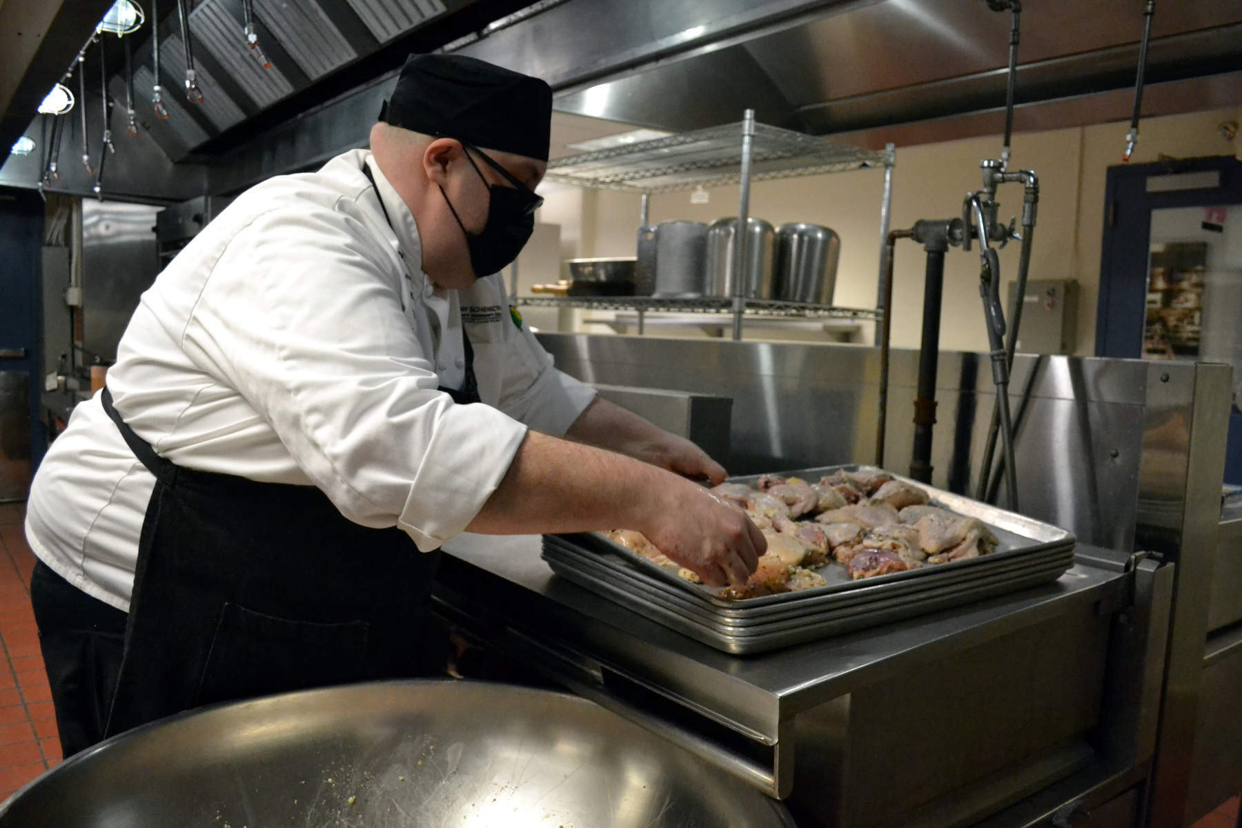 Chef Michael Stamets preparing chicken.