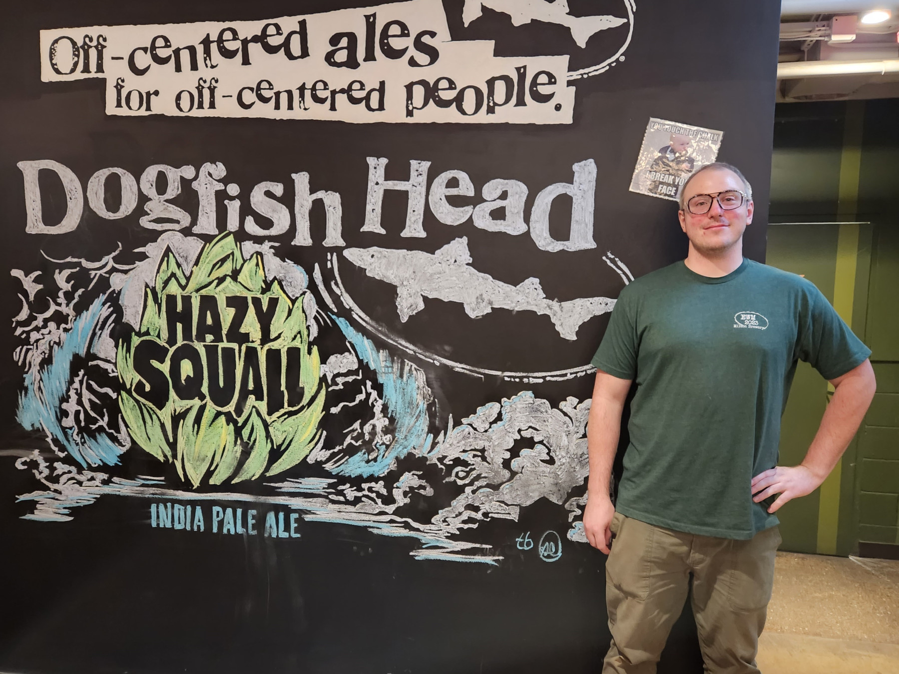 James Hanley standing in front of Dogfish Head Craft Brewery sign