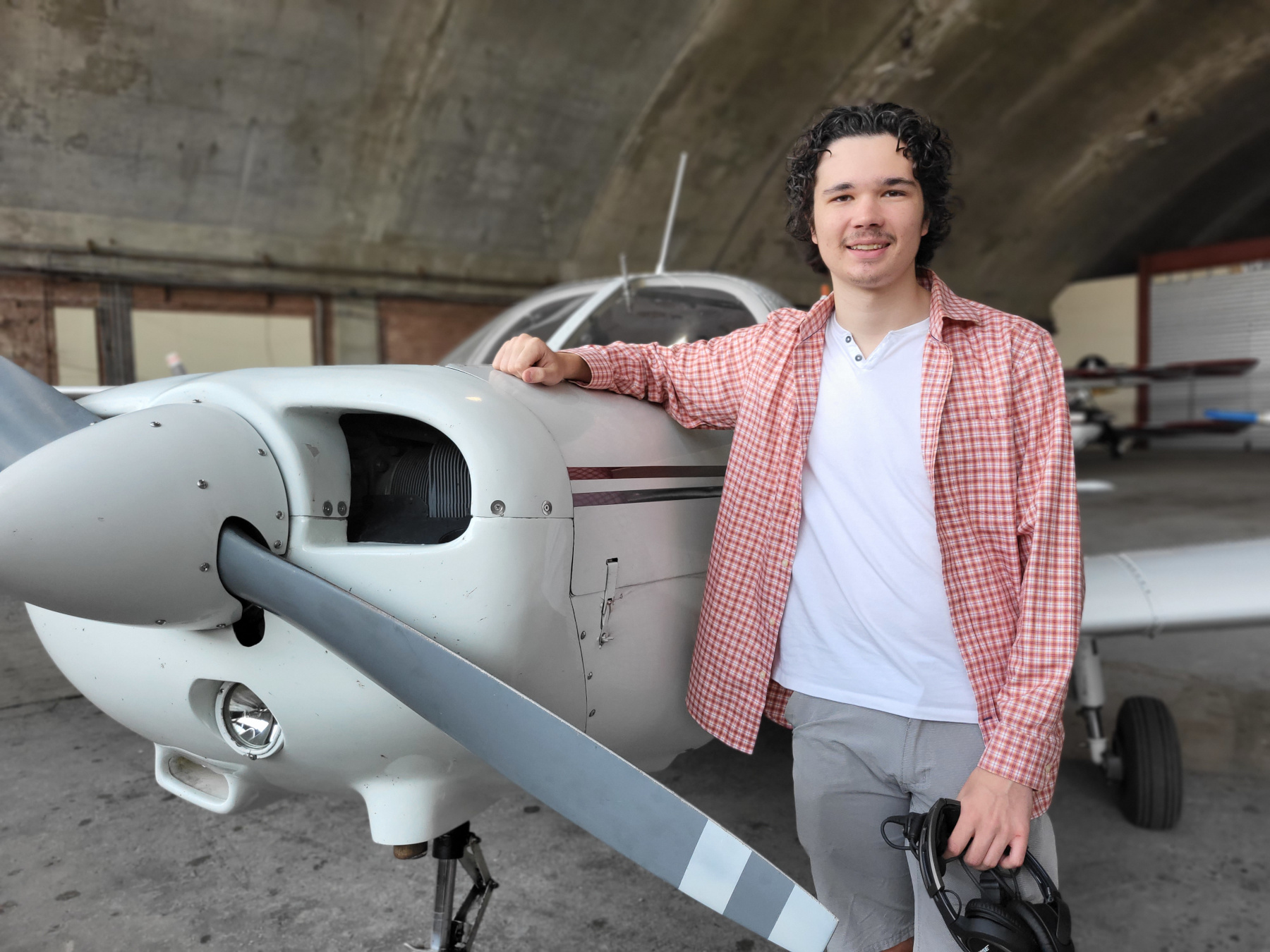 Jonathan Ryan standing by a small aircraft