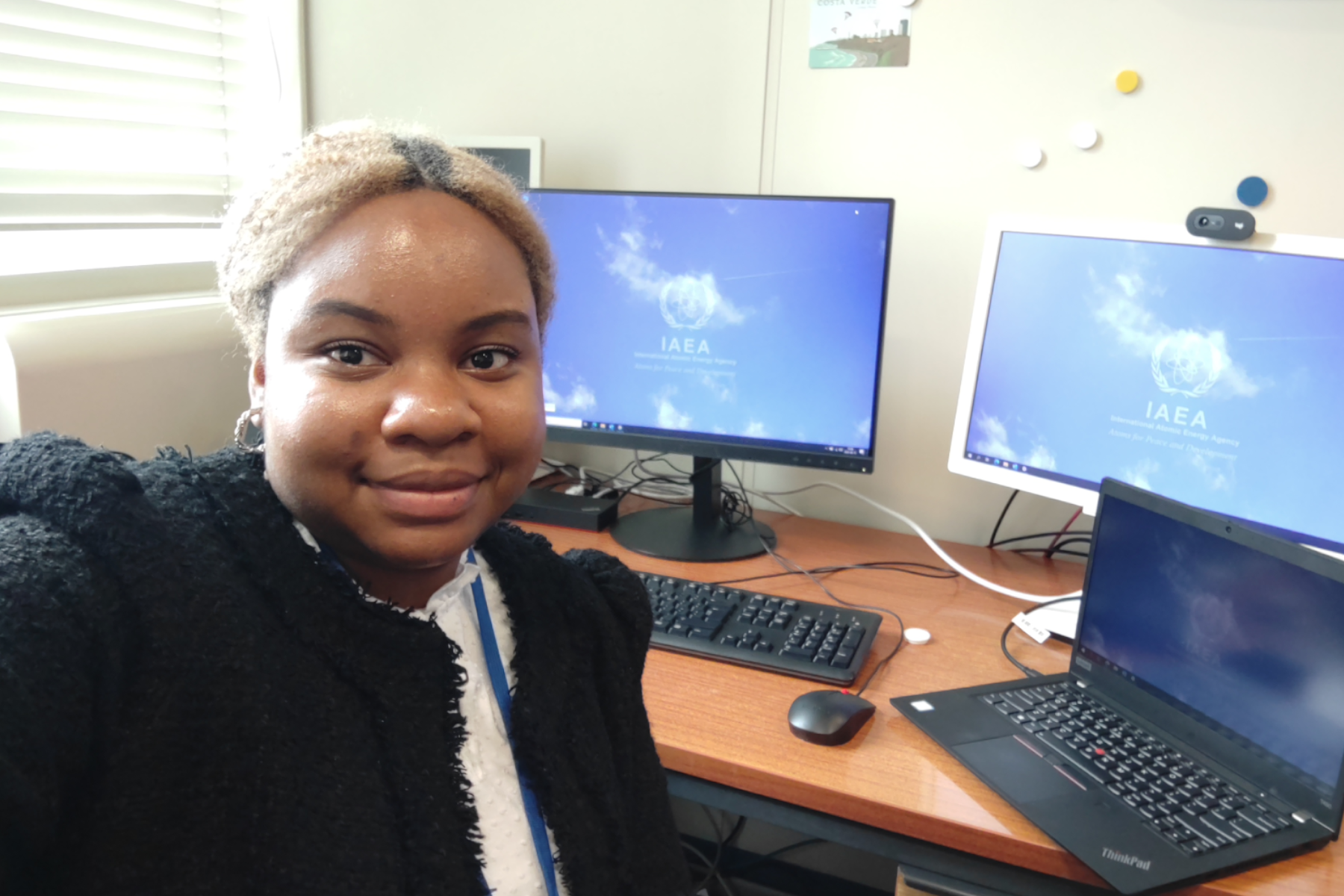 Nkeiru Ubadike, seated at laptop, smiling