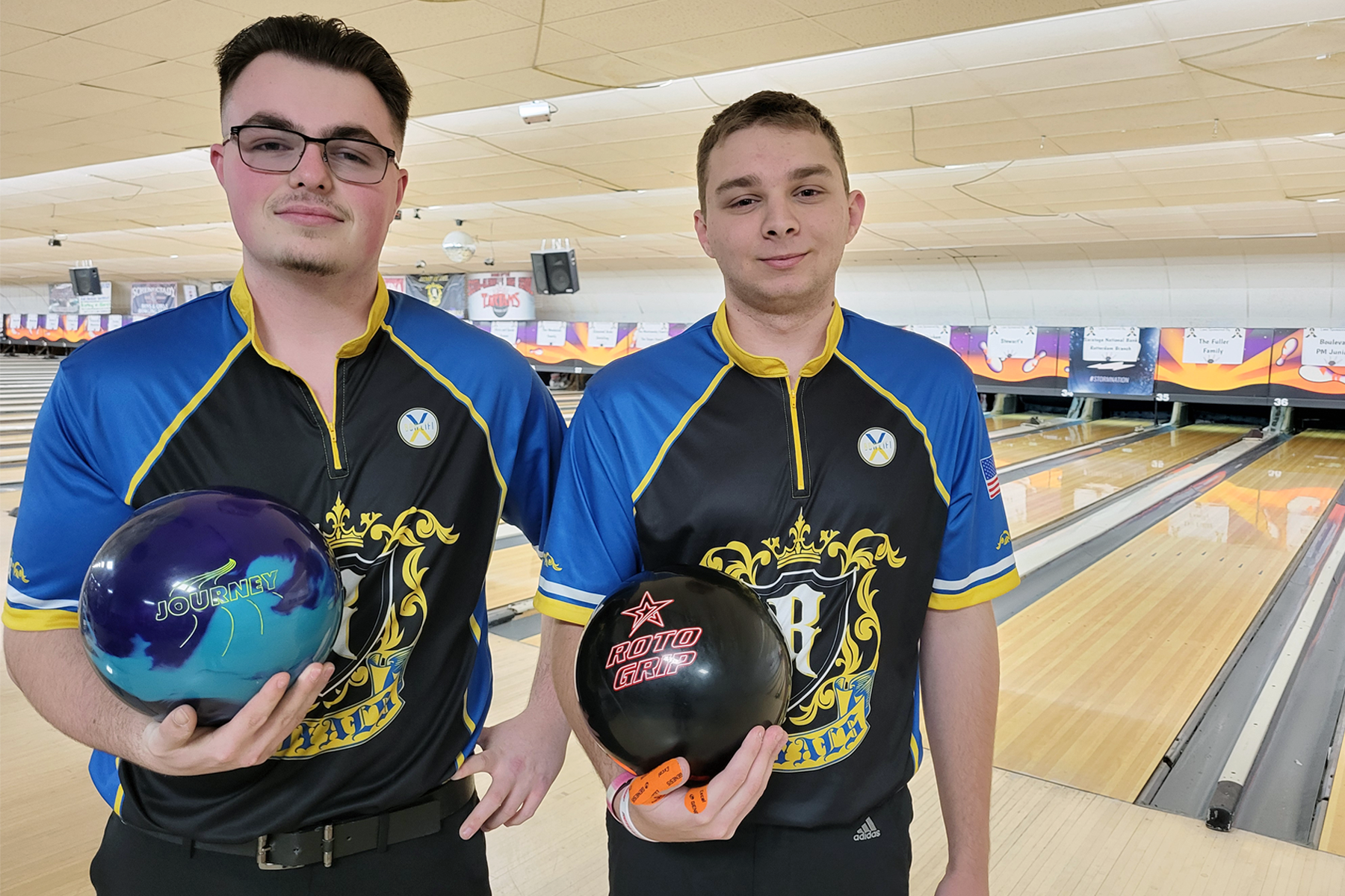 Rich Pitsas and Tyler Drexel holding bowling balls, at Boulevard Bowl