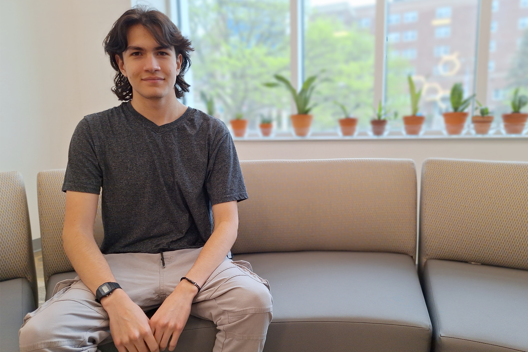Raymond Franco sitting in the Begley Learning Commons.